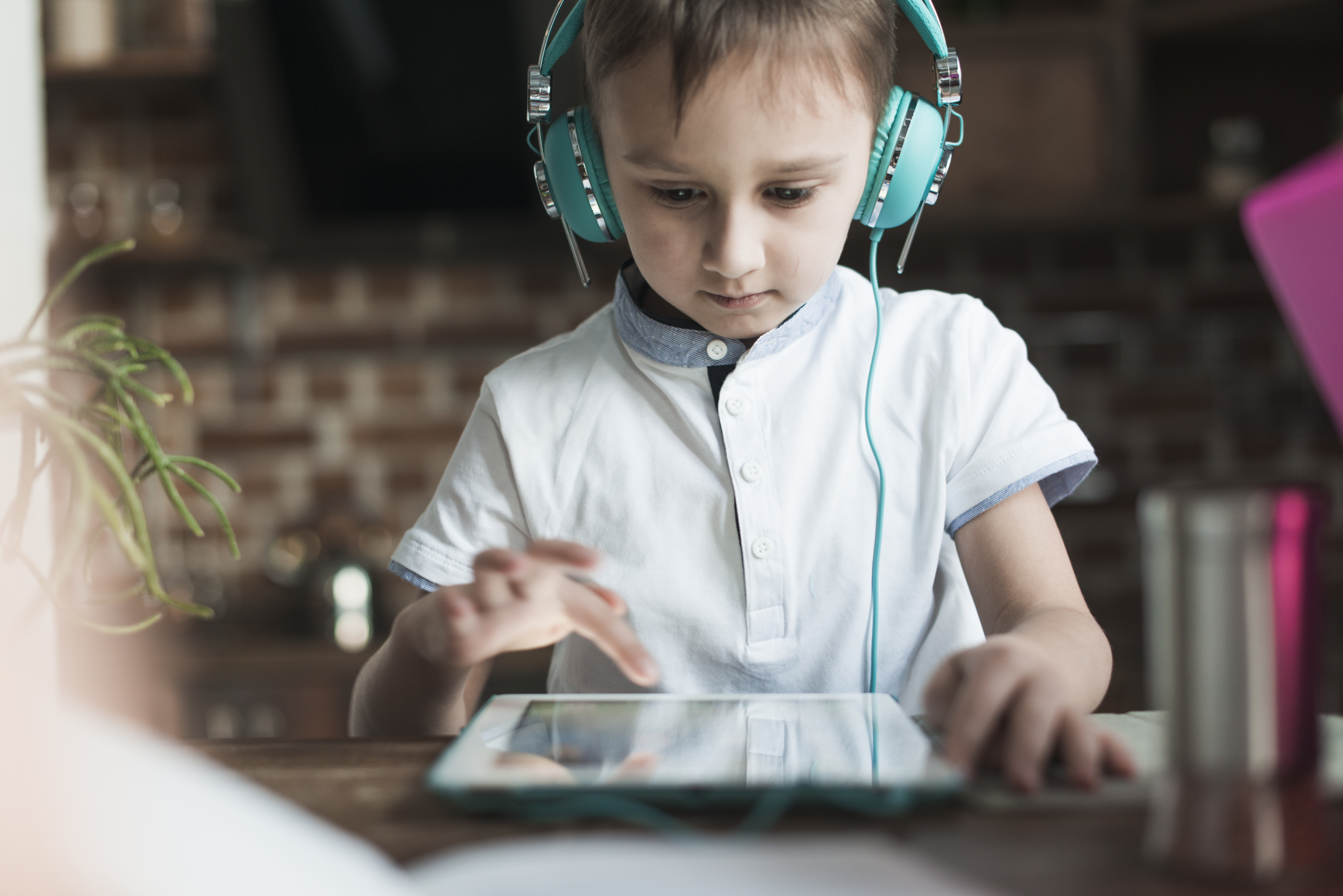 Child using an AAC device on a tablet